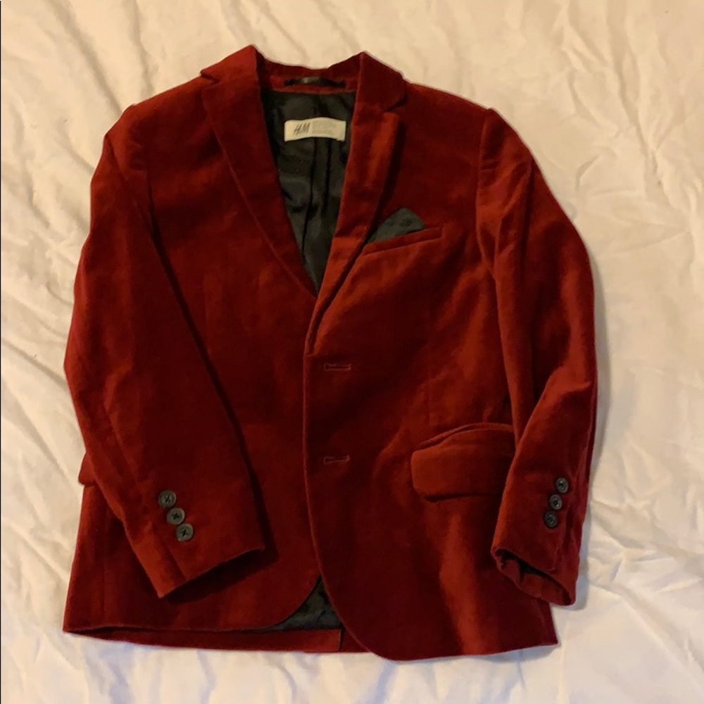 Red Valore blazer and black pants